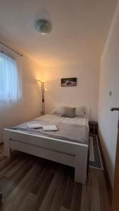 a bedroom with a large bed in a room at Apartman Anna & Kamp Elza in Bihać +27 photos