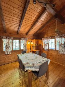 a dining room with a table and chairs at Etna Essence Chalet in Trecastagni