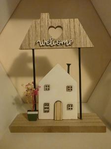 a welcome sign on top of a house on a shelf at COZY PANORAMA Flat in Alba Iulia
