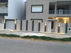 a house with a fence in front of it at Casa hersi in Hennchir Ksar Rhaleb +5 photos