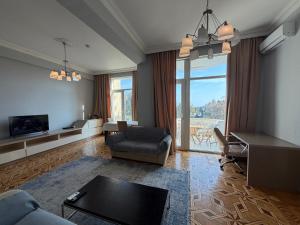 a living room with a couch and a table at Mayden Tower apartment in Baku