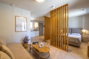 a living room with a couch and a bed at Cavaliere Seafront House - Theseus in Sami