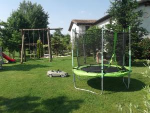 a swing set in a yard with a toy car at Agriturismo La Prateria in Gazzo