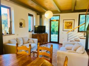 a living room with two couches and a table at Casa Jasmine by Lisetta in Migiana
