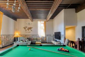 a living room with a pool table and a couch at La Vie de Château, proche Lyon in Bessenay