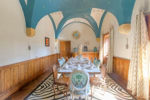 a dining room with a table and chairs at La Vie de Château, proche Lyon in Bessenay