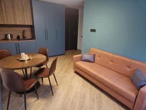 a living room with a couch and a table at Nemunėlio vitražai in Nemunėlio Radviliškis