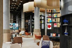 a lobby with chairs and tables in a building at Moxy Nice in Nice