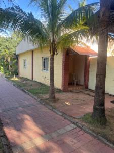 a house with two palm trees in front of it at grand oceana resort in Covelong