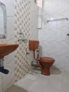 a bathroom with a toilet and a sink at Durga Beach Resort in Parxem +5 photos