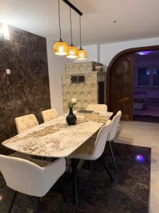 a dining room with a table and white chairs at Romantiksuite Euskirchen in Euskirchen +52 photos