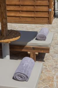 two towels sitting on a table in a room at Cavaliere Seafront House - Theseus in Sami +28 photos