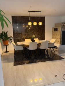 a dining room with a table and white chairs at Romantiksuite Euskirchen in Euskirchen