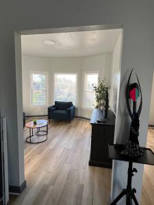 a living room with a couch and a table at Midtown Detroit Upper Retreat in Detroit