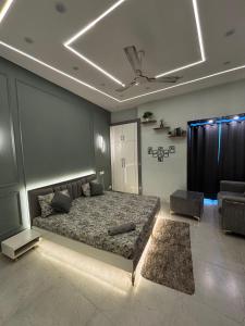 a bedroom with a bed and a couch at THE MOONLIGHT STUDIo in Noida