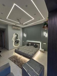 a living room with a bed and a ceiling at THE MOONLIGHT STUDIo in Noida