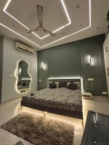 a bedroom with a bed and a mirror and a rug at THE MOONLIGHT STUDIo in Noida