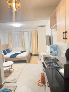 a kitchen and living room with a bed in the background at Bliss Homes in Nairobi