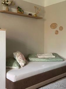 a bed with two pillows on top of it at Gartenblick in Bad Elster