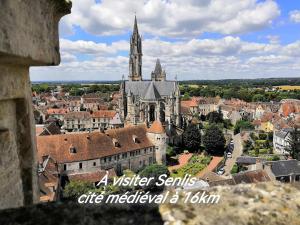 a view of a medieval city with a church at Augrenierdelachaumine in Précy-sur-Oise