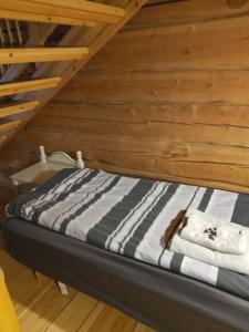 a bed in a room with a wooden ceiling at Arctic house in Rovaniemi +57 photos