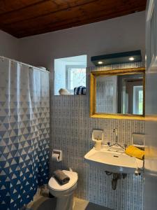 a bathroom with a sink and a toilet and a mirror at Anezo's Exceptional View in Spetses +47 photos