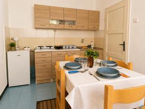 a kitchen with a table with plates on it at Apartman Mediteran in Herceg-Novi +18 photos