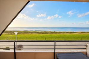 a view of the ocean from the balcony of a house at Haus Nige Wark - Ferienwohnungen in Cuxhaven