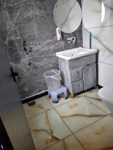 a bathroom with a sink and a mirror at Hotel Sahajtam Inn in Sonīpat +12 photos