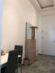 a room with a table and two chairs and a refrigerator at Tayfun-Living in Vienna