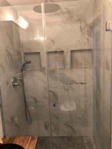 a shower with a glass door in a bathroom at Tayfun-Living in Vienna