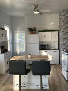 a kitchen with a wooden table and two chairs at Midtown Detroit Upper Retreat in Detroit