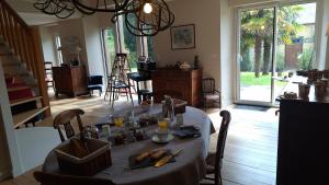 a dining room with a table with food on it at La Peuterne in Mouazé +8 photos