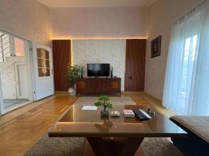 a living room with a tv and a coffee table at Blue Escape in Danilovgrad