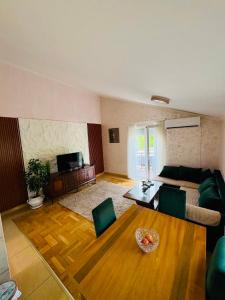 a living room with a couch and a table at Blue Escape in Danilovgrad