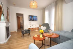 a living room with a couch and a table at Apartments Katušić in Cavtat