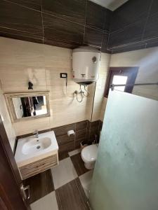 a small bathroom with a sink and a toilet at Santa Maria Dahab Hotel in Dahab +38 photos