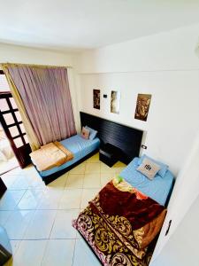 a living room with two beds and a couch at Santa Maria Dahab Hotel in Dahab