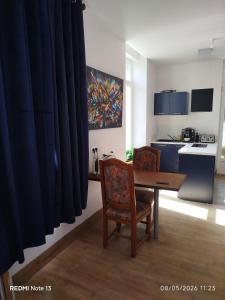 a kitchen with a table and two chairs and a dining room at Gîte "fils de laine" Piscine chauffée interieure et Sauna ouverts toute l'année in Celles-sur-Plaine