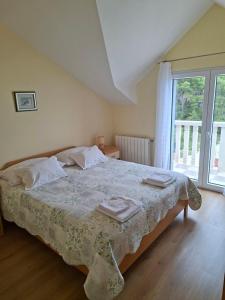 a bedroom with a bed with two towels on it at Apartments Elvira in Sveta Nedelja