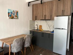 a kitchen with a table and a refrigerator at Euro Palace Gonio in Gonio