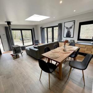a living room with a table and a couch at Deep Forest in Bastogne