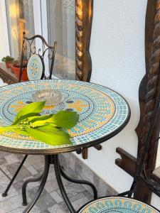 a table with a plate with a plant on it at Domeniul Ursului in Vadu Izei