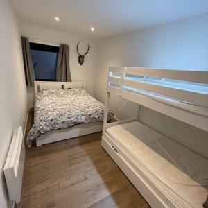 a bedroom with a bunk bed and a window at Deep Forest in Bastogne