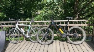 two bikes are parked on a wooden deck at Deep Forest in Bastogne