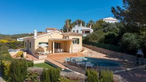 a villa with a swimming pool and a house at V155 Villa Llebeig in Son Bou