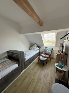 a bedroom with two bunk beds and a chair at Gaststätte Bongsiel 'Dat Swarte Peerd' in Ockholm
