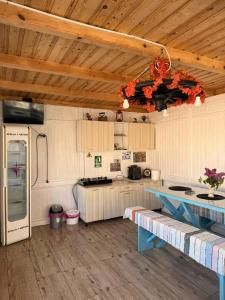 a kitchen with wooden ceilings and a blue table at Casa Alexander in Sulina