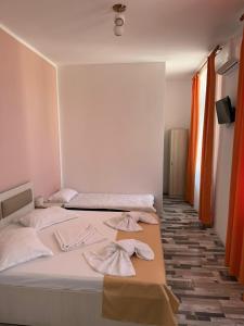 a bedroom with a bed with towels on it at Casa Alexander in Sulina +3 photos