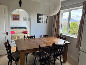 a dining room with a wooden table and chairs at 19 Westlands in Westport